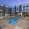 a pool in a courtyard with seating