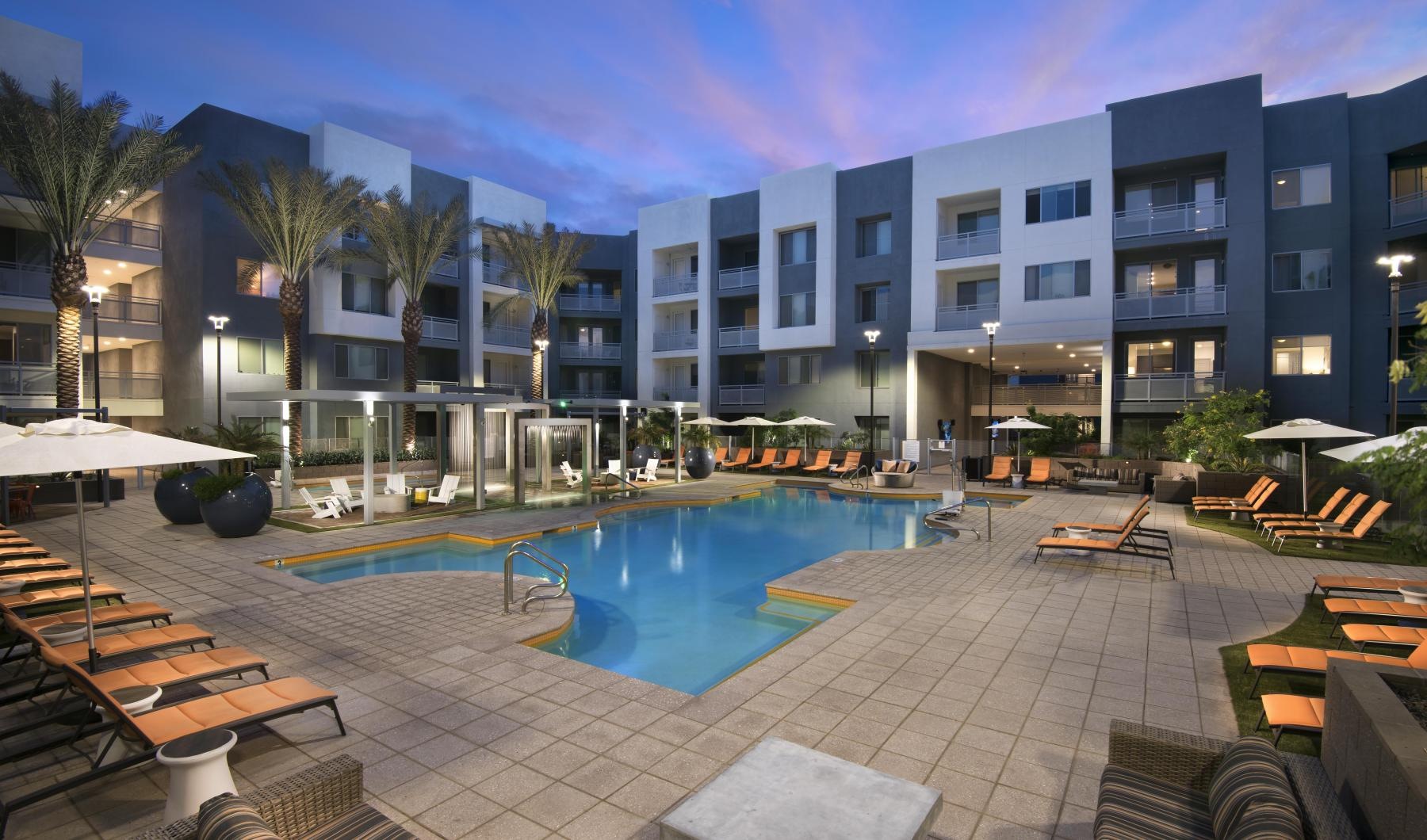 a pool in a courtyard with seating