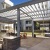 a building with a patio and a grilling area table and chairs