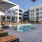 a pool with chairs and umbrellas