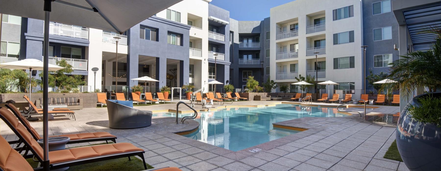 a pool with chairs and umbrellas